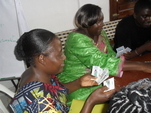 Health workers play card games in training session on malaria diagnosis and treatment