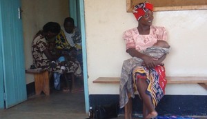 Woman and child wait at health care facility in Uganda