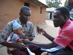 Dr. Herry Kasara examines a sick child in Rufiji District